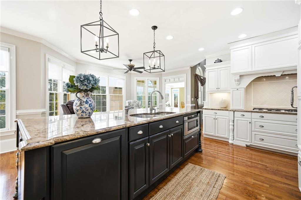 2855 Strathmore Drive Cumming, GA 30041 - Photo 20 of 96 a kitchen with white cabinets and chandelier