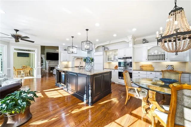 a kitchen with stainless steel appliances granite countertop a refrigerator and cabinets