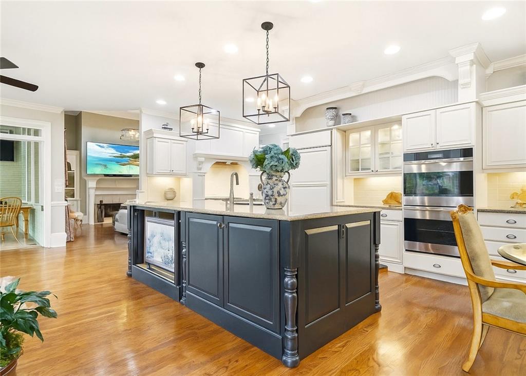 2855 Strathmore Drive Cumming, GA 30041 - Photo 27 of 96 a kitchen with stainless steel appliances granite countertop a stove a sink and a wooden floors