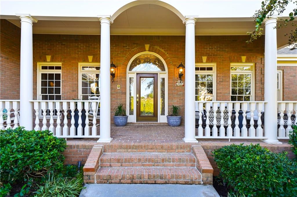 2855 Strathmore Drive Cumming, GA 30041 - Photo 3 of 96 a view of a brick house with large windows and a garden