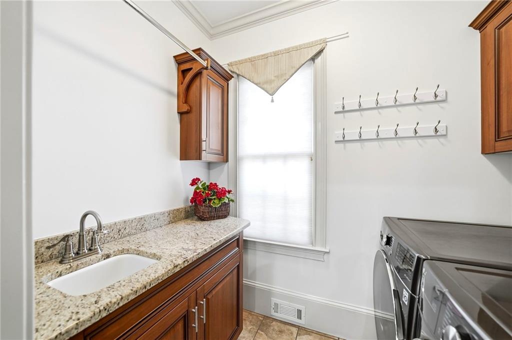 2855 Strathmore Drive Cumming, GA 30041 - Photo 39 of 96 a bathroom with a granite countertop sink and a mirror