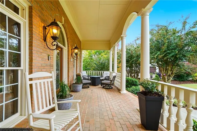 a view of a chair and tables in the balcony