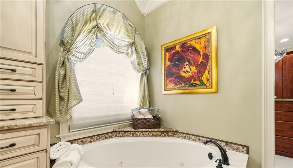 2855 Strathmore Drive Cumming, GA 30041 - Photo 43 of 96 a bathroom with a tub and a painting on the wall