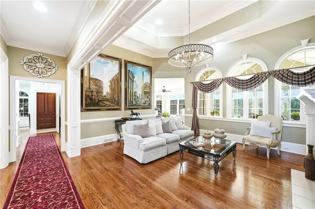 a living room with furniture a fireplace and a floor to ceiling window