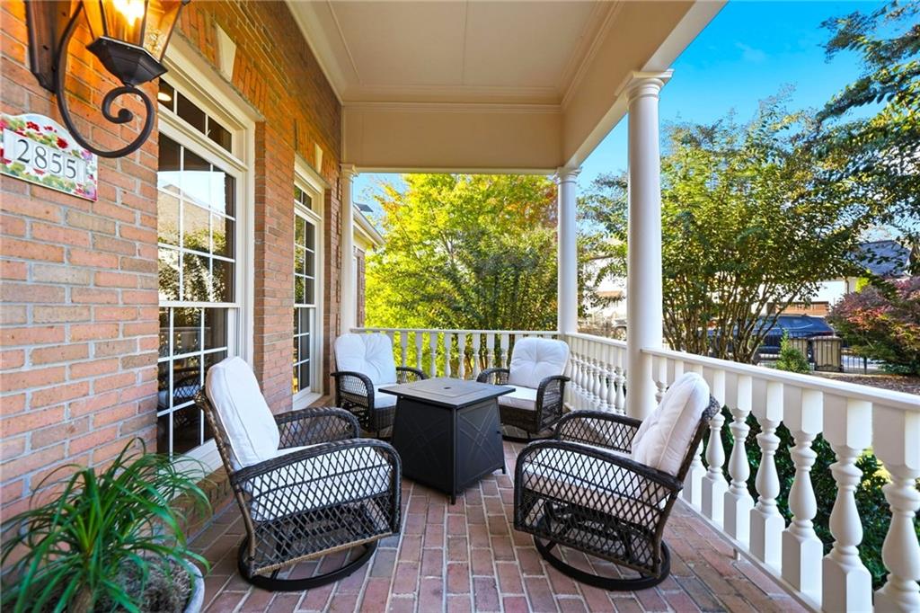 2855 Strathmore Drive Cumming, GA 30041 - Photo 5 of 96 a view of a chair and tables in the balcony