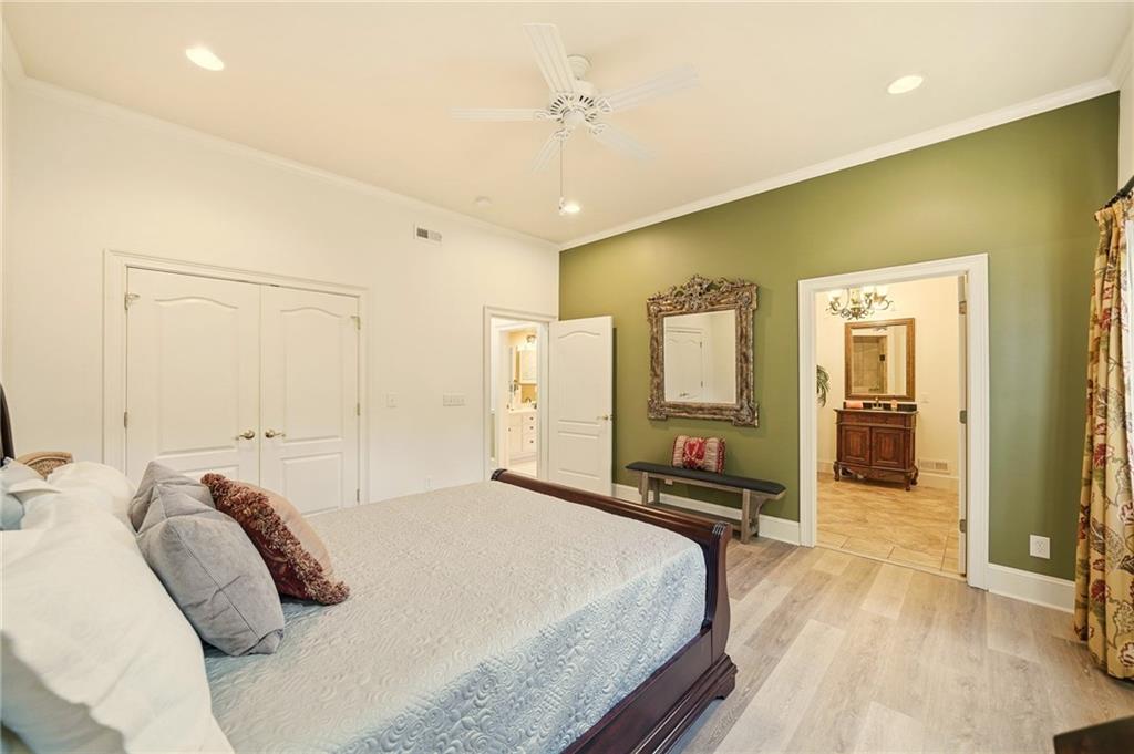 2855 Strathmore Drive Cumming, GA 30041 - Photo 63 of 96 a bedroom with a bed and wooden floor