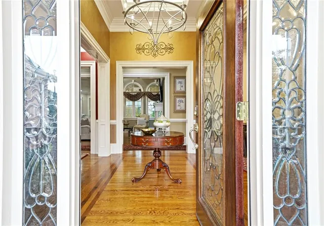 a view of a dining room with furniture and chandelier