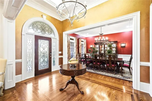 a view of a dining room with furniture wooden floor and chandelier