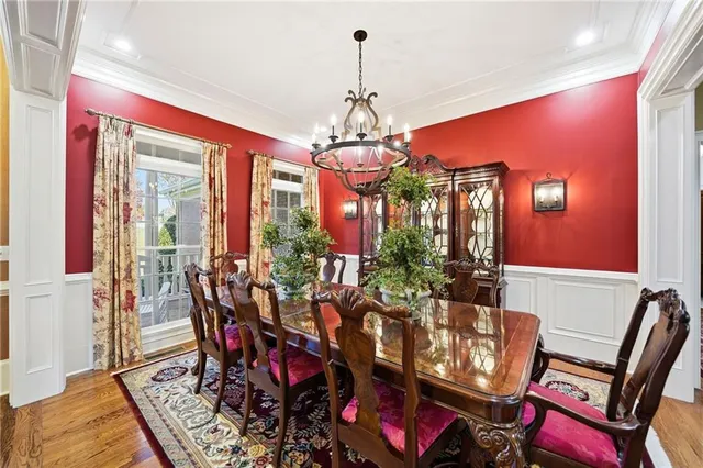 a living room with furniture a rug and a potted plant