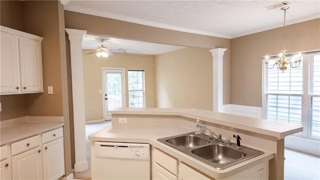 a kitchen with a sink stove and cabinets