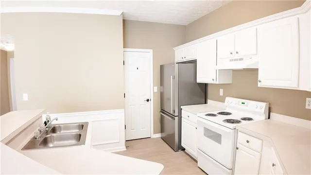 a kitchen with a sink a stove and refrigerator