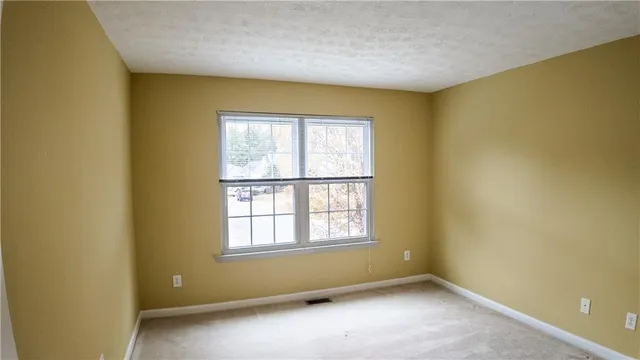 an empty room with a empty space and a window