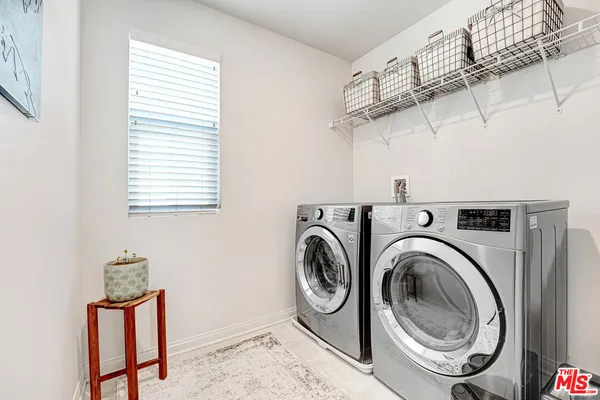 a view of a storage & utility room with washer and dryer