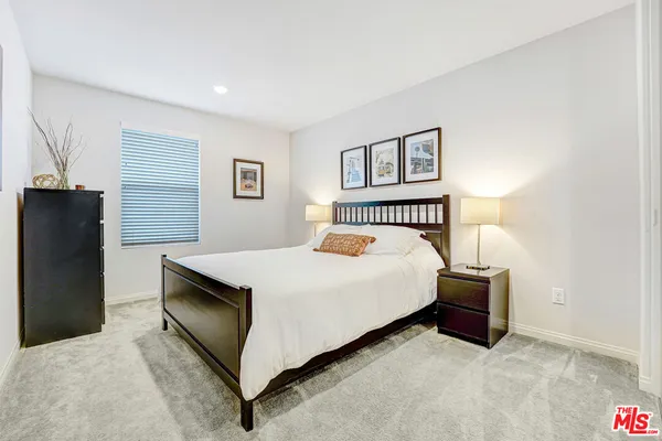 a bedroom with a bed and a lamp with window