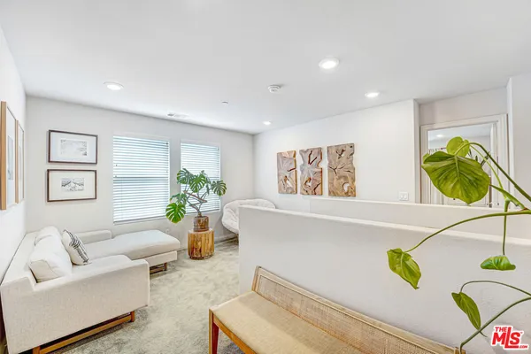 a living room with furniture and flowers
