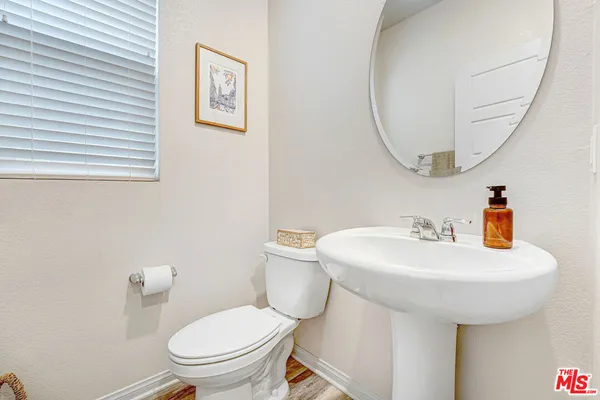 a bathroom with a sink a mirror and a toilet