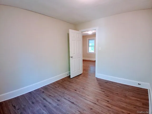 a view of a room with wooden floor and furniture