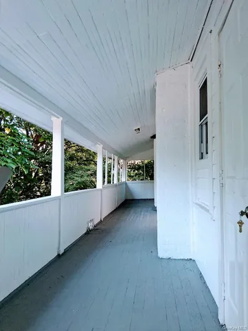 a kitchen with granite countertop a stove top oven a sink dishwasher a refrigerator and a dining table with wooden floor