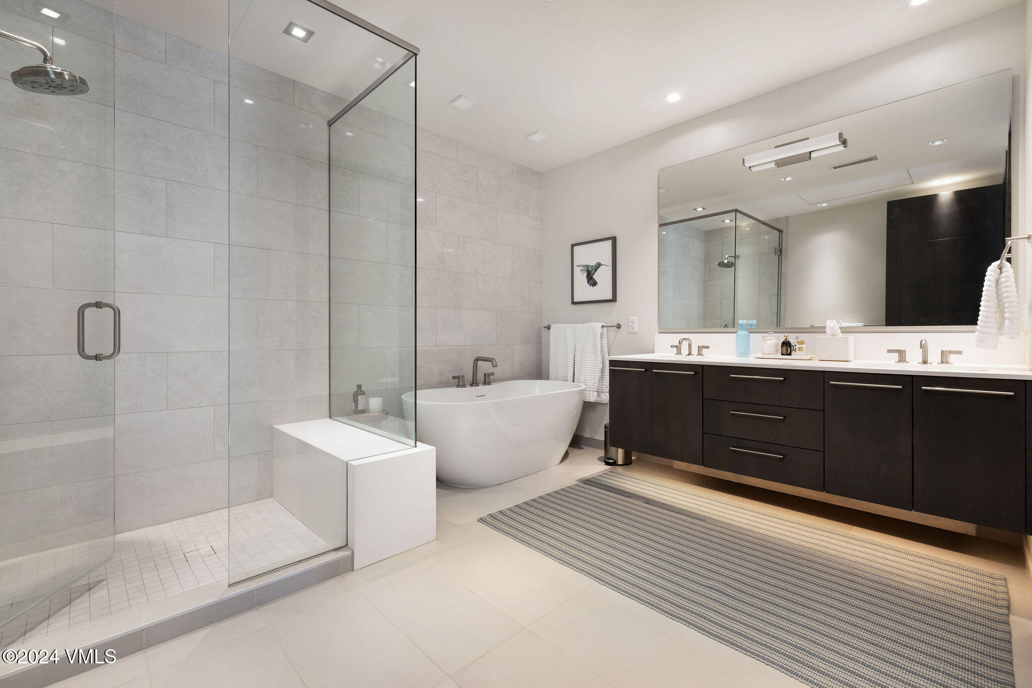 430 South Frontage Road East, Unit RU301 Vail, CO 81657 - Photo 12 of 29 a spacious bathroom with a double vanity sink a large mirror and a bathtub