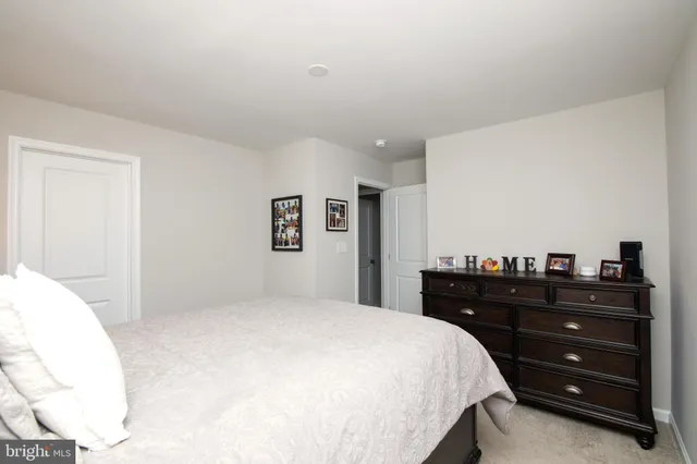 a bedroom with a bed and a mirror