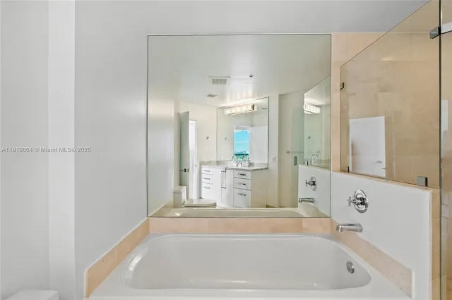 a bathroom with a bathtub and a shower
