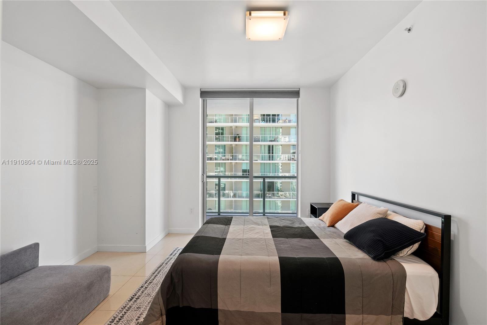 1111 Southwest 1st Avenue, Unit 2414N Miami, FL 33130 - Photo 25 of 49 a bedroom with a bed and a window