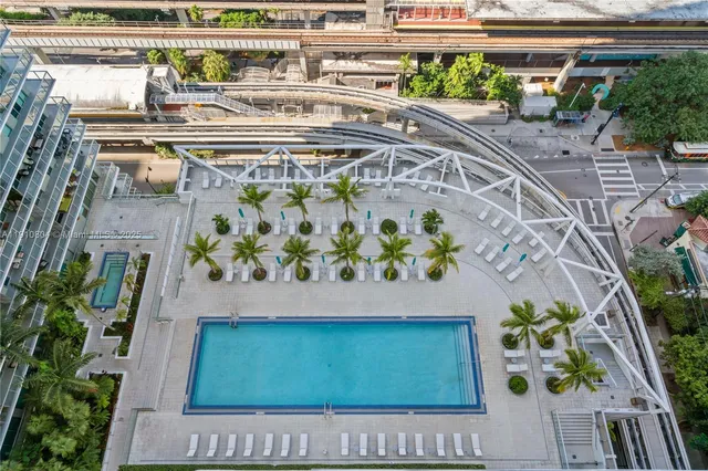 a view of a big building with a big yard and plants