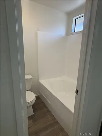a view of a bathroom with sink and wooden floor
