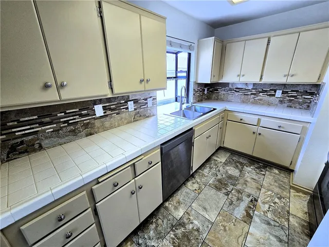 a kitchen with a stove a sink and a refrigerator