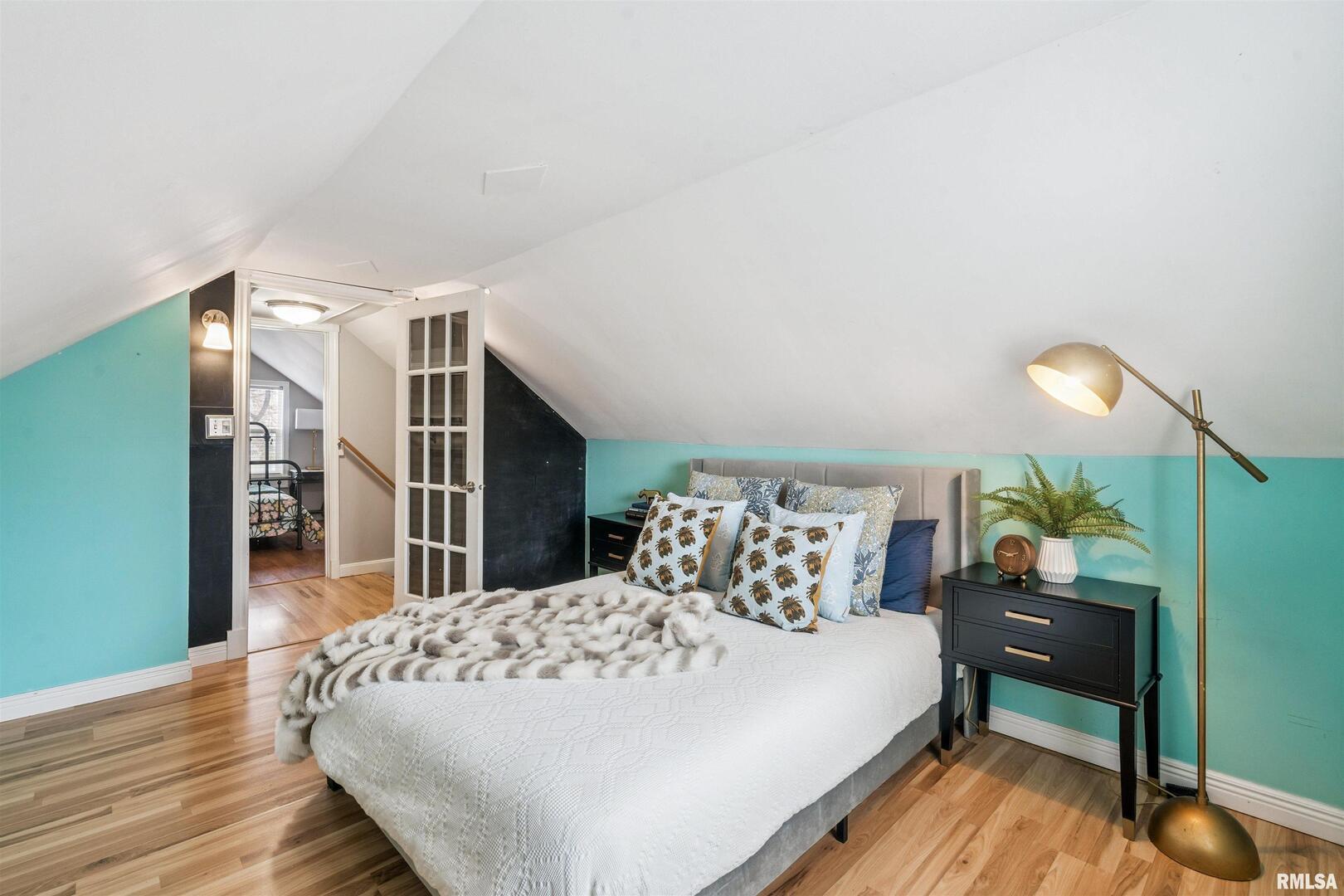 126 South Genessee Street Blue Grass, IA 52726 - Photo 11 of 22 a bedroom with a bed and a table