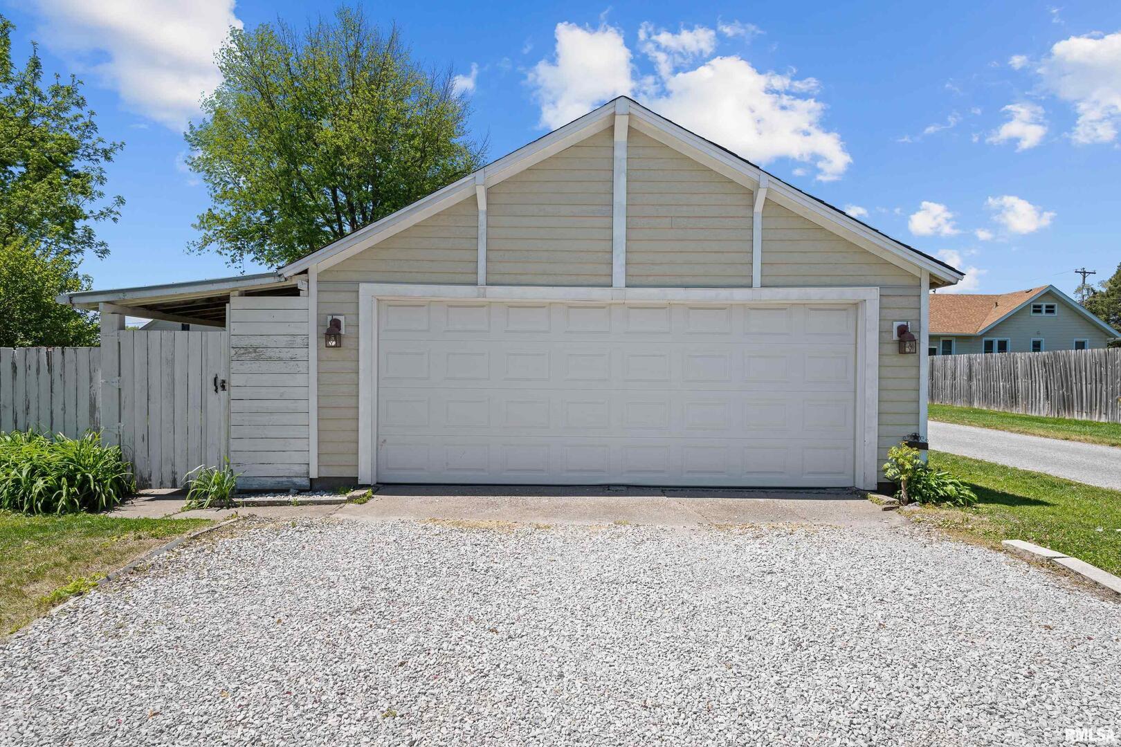 126 South Genessee Street Blue Grass, IA 52726 - Photo 15 of 22 a view of backyard of house with wooden fence