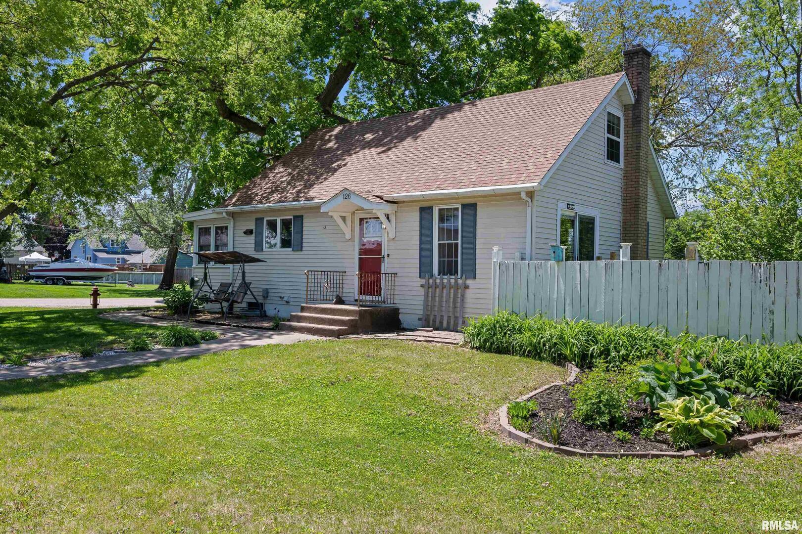 126 South Genessee Street Blue Grass, IA 52726 - Photo 17 of 22 a view of a house with a yard and sitting area