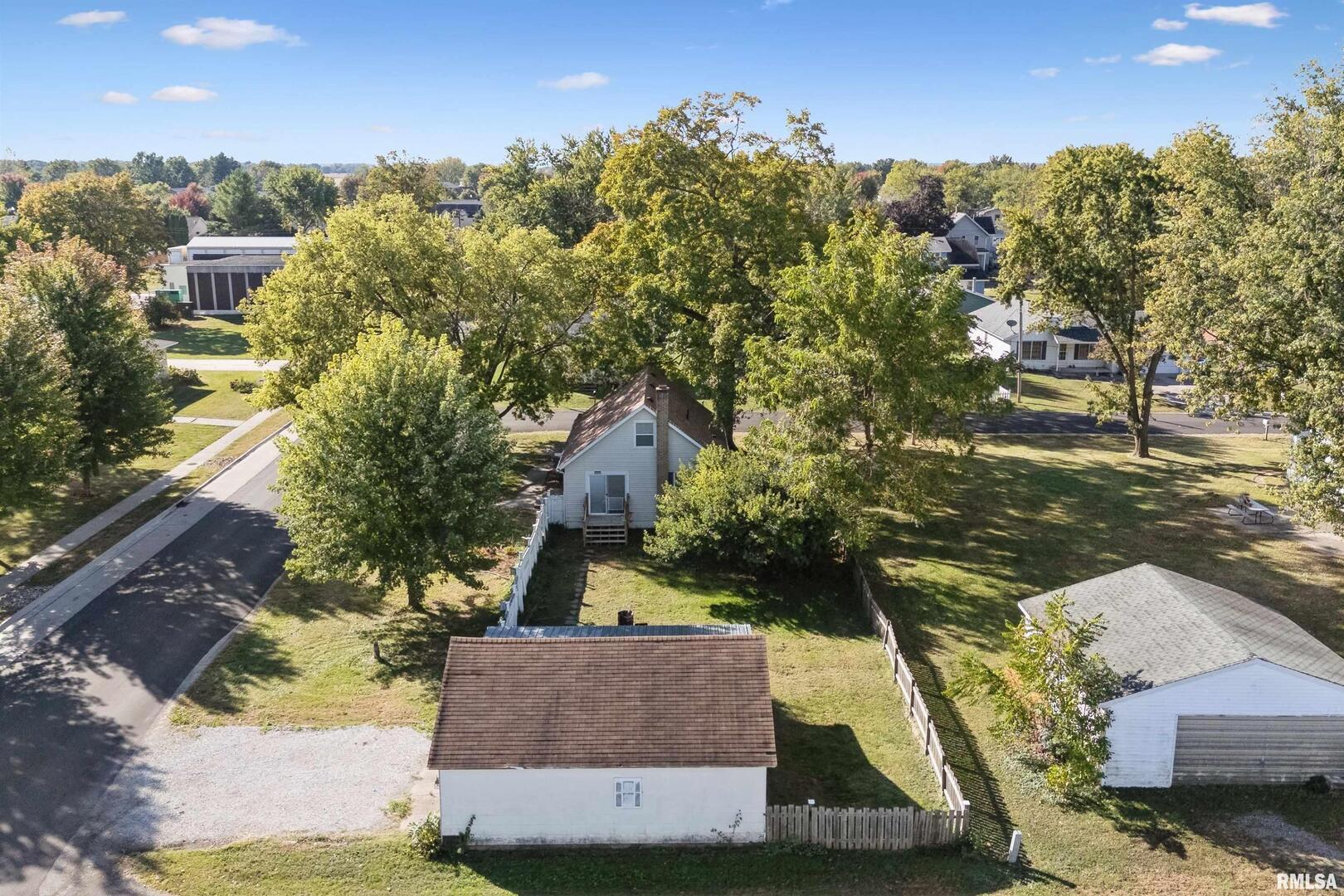 126 South Genessee Street Blue Grass, IA 52726 - Photo 19 of 22 an aerial view of a house with a yard basket ball court and outdoor seating