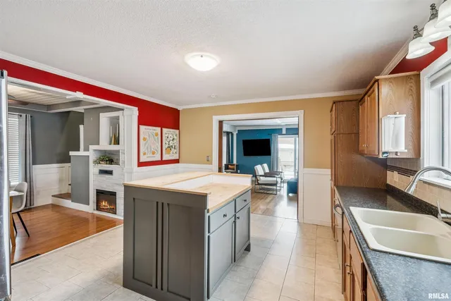 a kitchen with a sink stove and a refrigerator