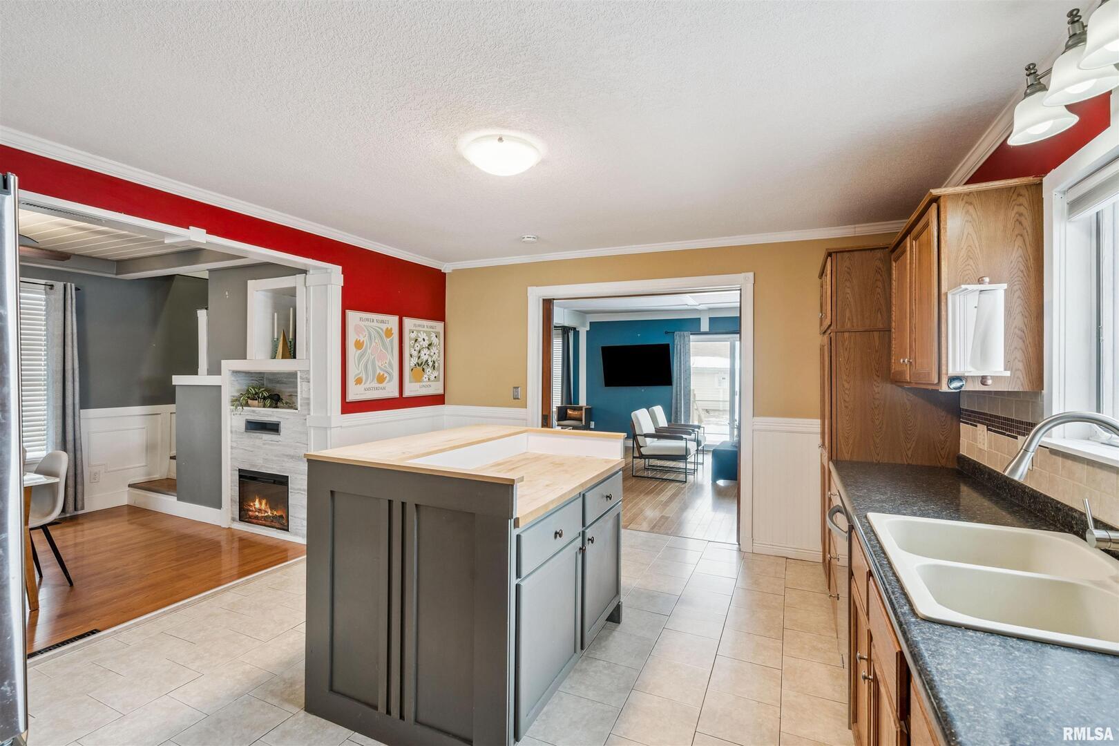 126 South Genessee Street Blue Grass, IA 52726 - Photo 5 of 22 a kitchen with a sink stove and a refrigerator