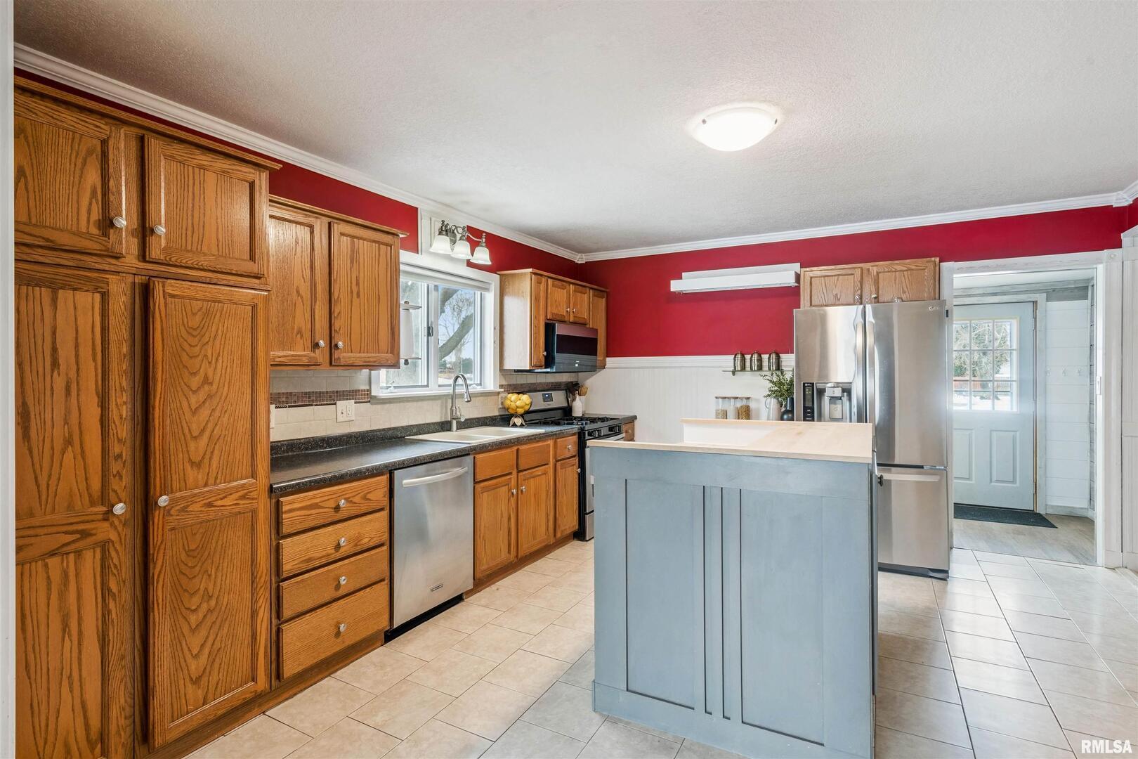 126 South Genessee Street Blue Grass, IA 52726 - Photo 7 of 22 a kitchen with stainless steel appliances granite countertop a refrigerator and a sink