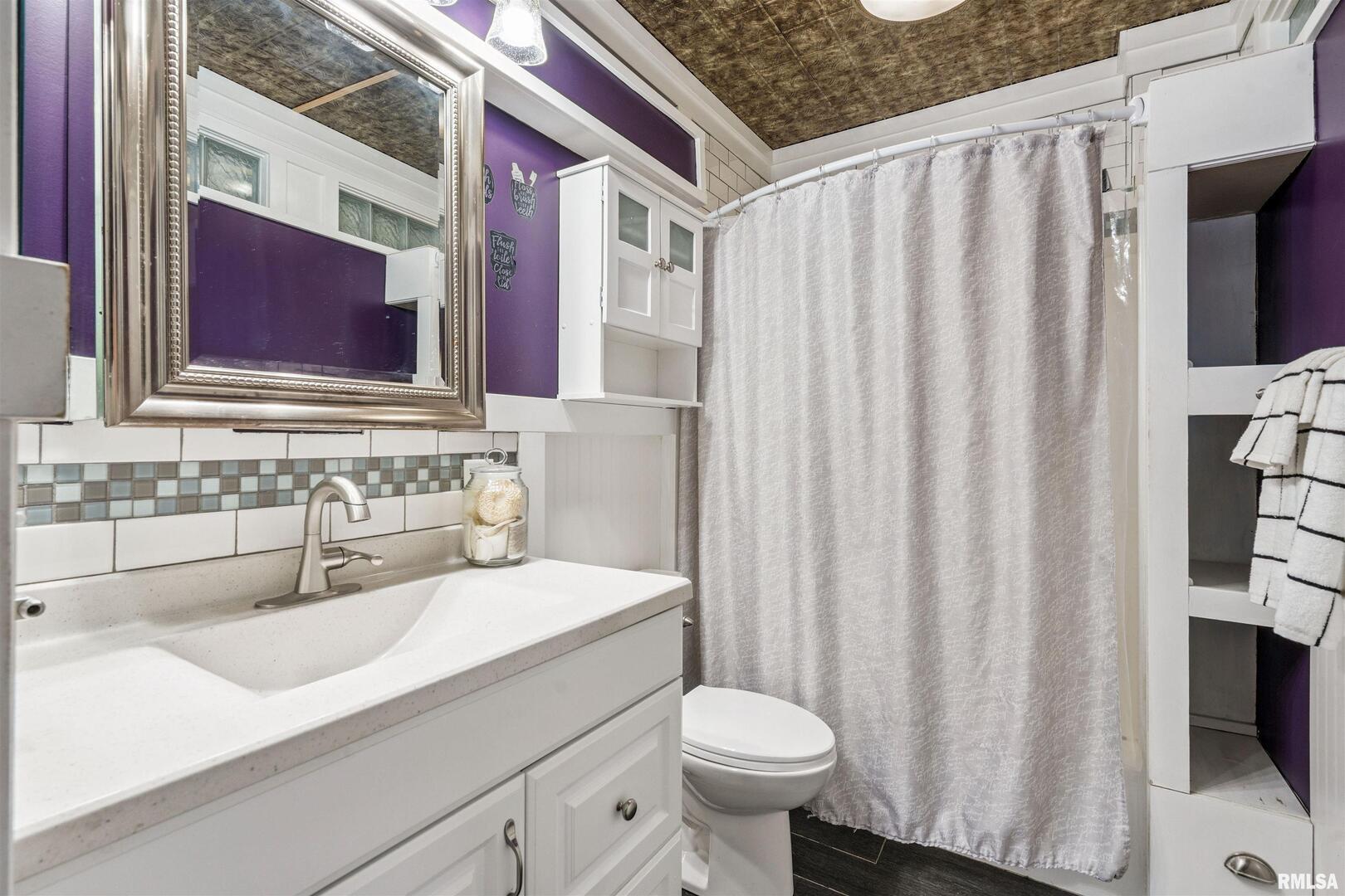 126 South Genessee Street Blue Grass, IA 52726 - Photo 10 of 22 a bathroom with a sink toilet and shower