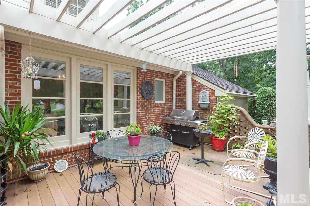 1405 Hunting Ridge Road Raleigh, NC 27615 - Photo 22 of 30 a backyard of a house with table and chairs