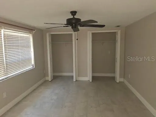 a view of empty room with ceiling fan
