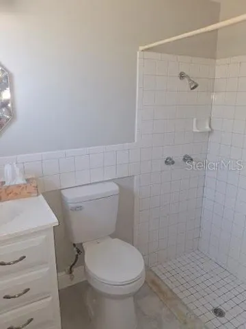 a white toilet sitting next to a bathroom sink