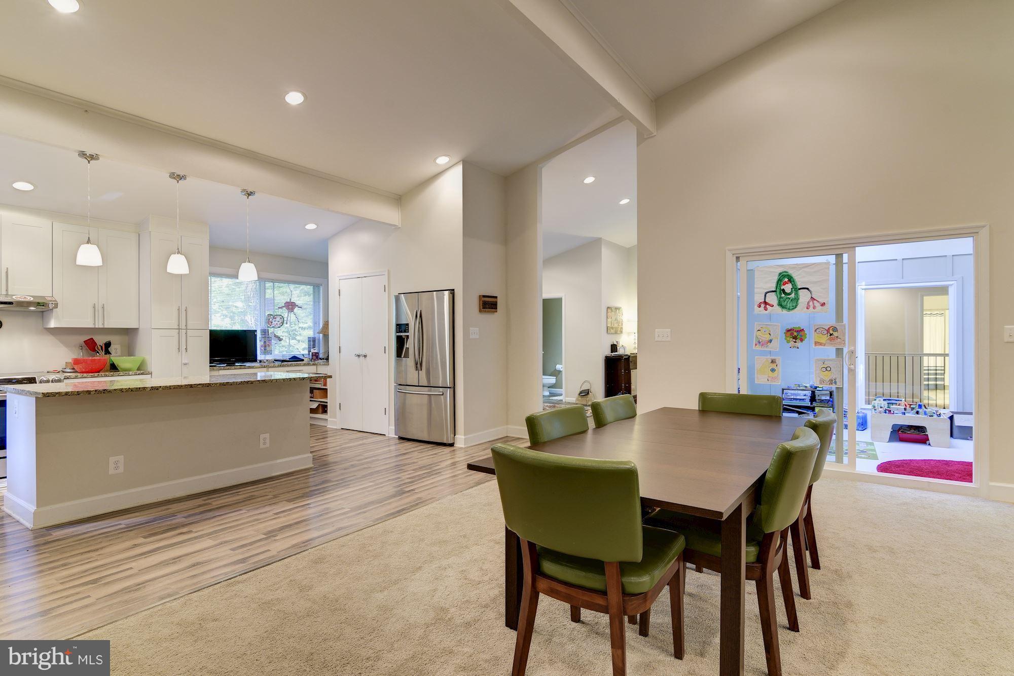 7608 Hamilton Spring Road Bethesda, MD 20817 - Photo 13 of 21 a dining hall with stainless steel appliances a dining table and chairs