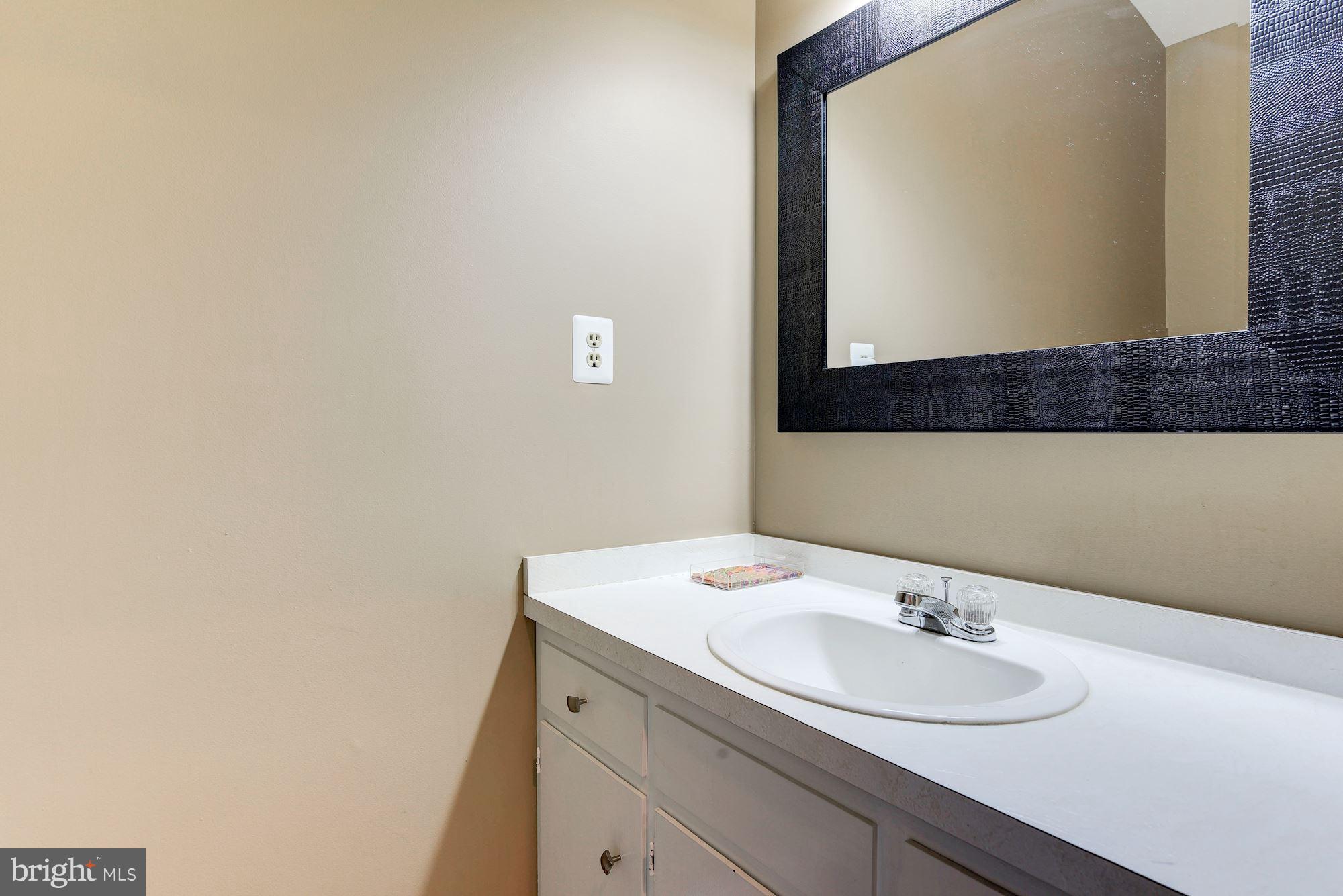 7608 Hamilton Spring Road Bethesda, MD 20817 - Photo 16 of 21 a bathroom with a sink and a mirror