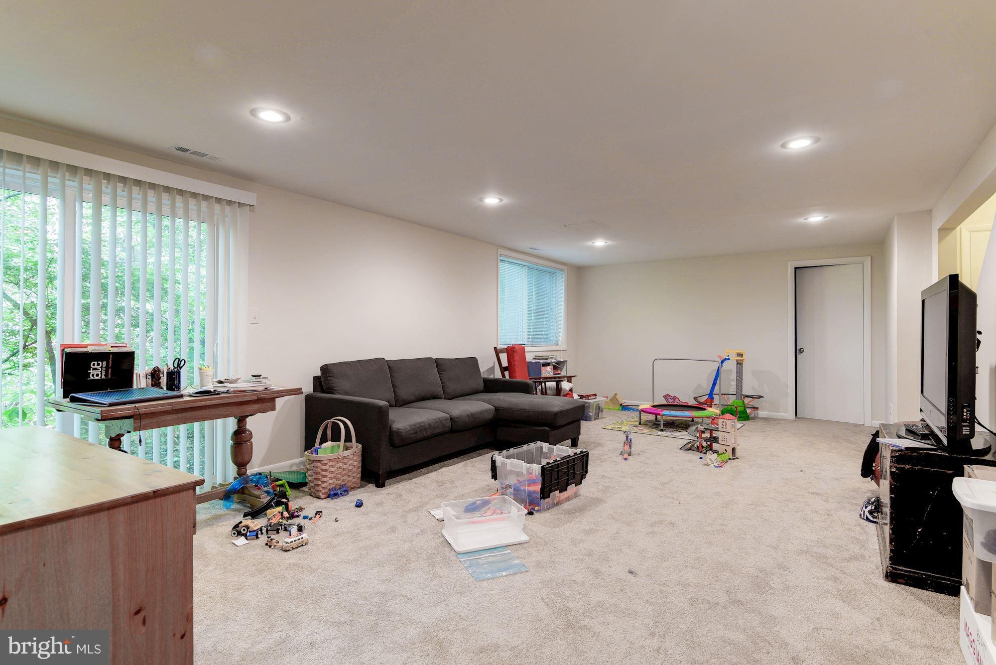 7608 Hamilton Spring Road Bethesda, MD 20817 - Photo 18 of 21 a living room with furniture and a fireplace