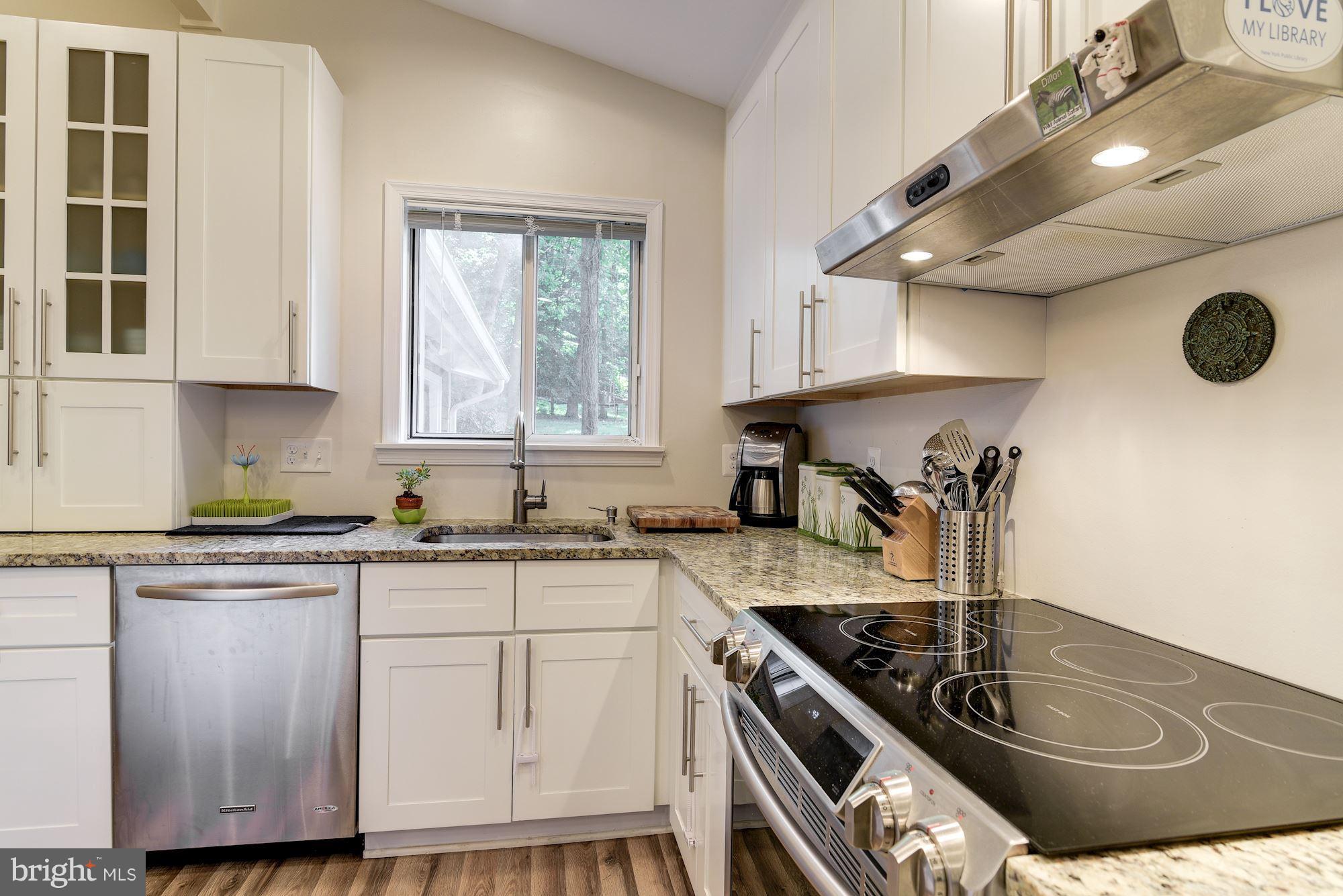 7608 Hamilton Spring Road Bethesda, MD 20817 - Photo 5 of 21 a kitchen with granite countertop a sink a stove and cabinets