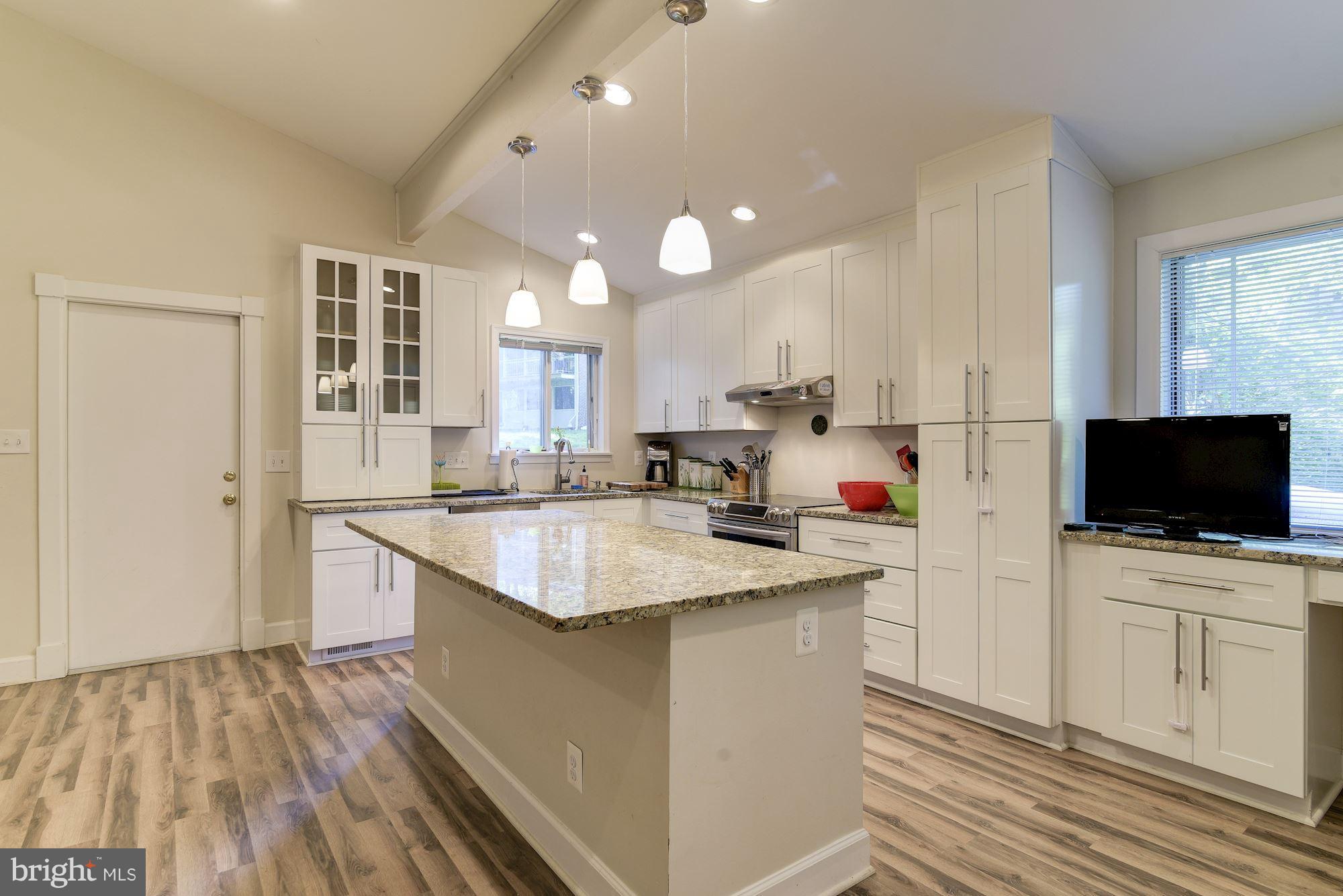 7608 Hamilton Spring Road Bethesda, MD 20817 - Photo 6 of 21 a kitchen with a sink a counter top space stainless steel appliances and cabinets