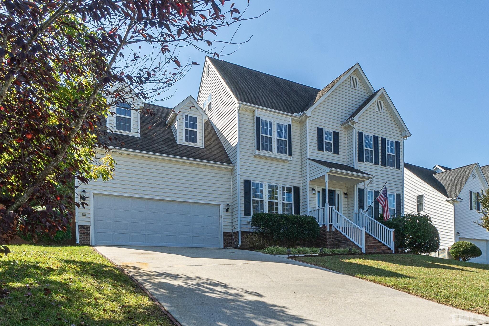 4812 Elmhurst Ridge Court Raleigh, NC 27616 - Photo 2 of 23 a front view of a house with a yard and garage