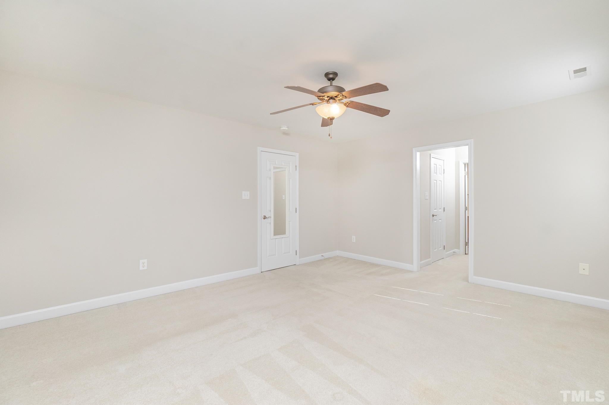 4812 Elmhurst Ridge Court Raleigh, NC 27616 - Photo 16 of 23 an empty room with a window and a ceiling fan