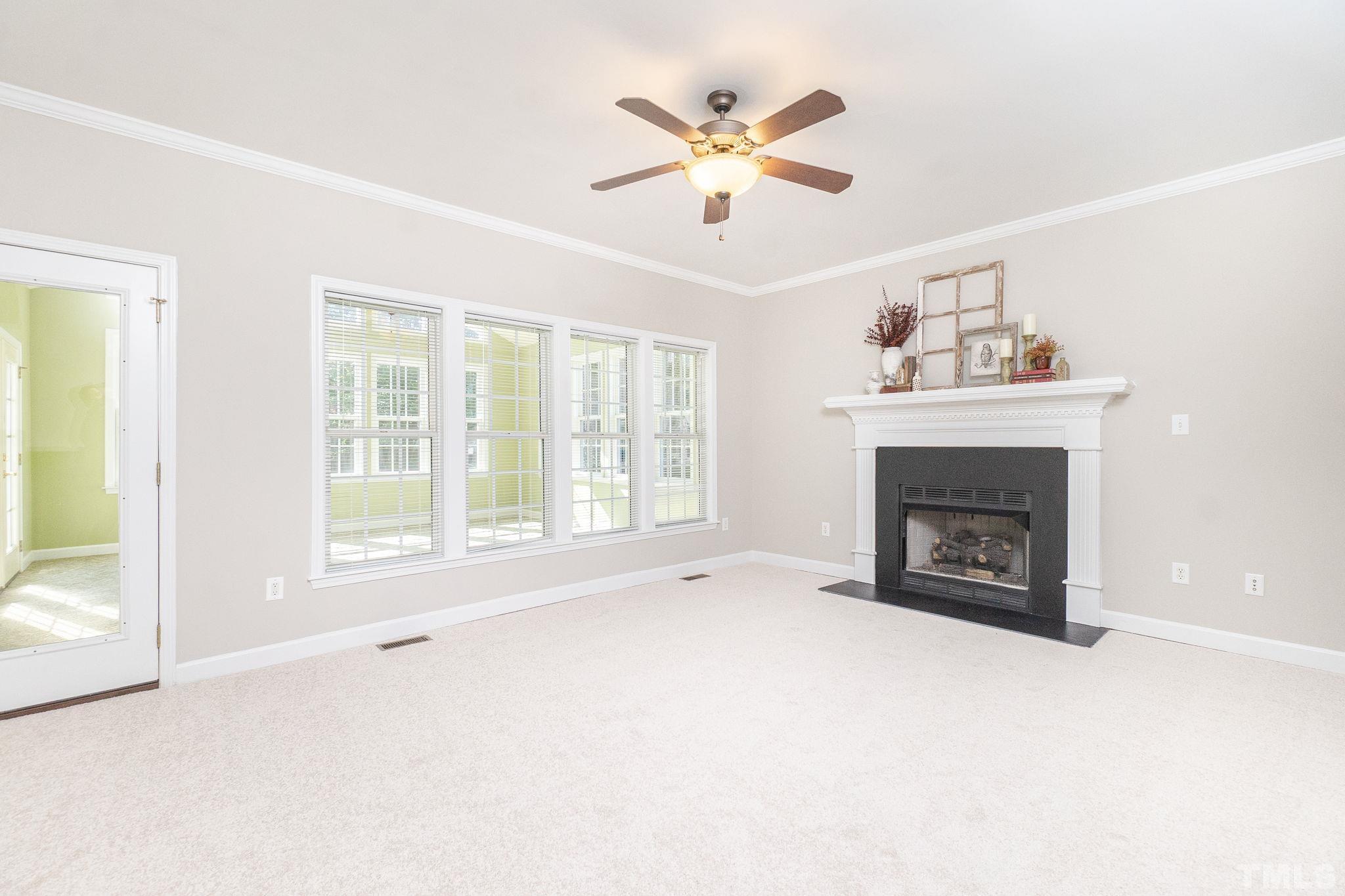 4812 Elmhurst Ridge Court Raleigh, NC 27616 - Photo 5 of 23 a view of an empty room with a fireplace and a window