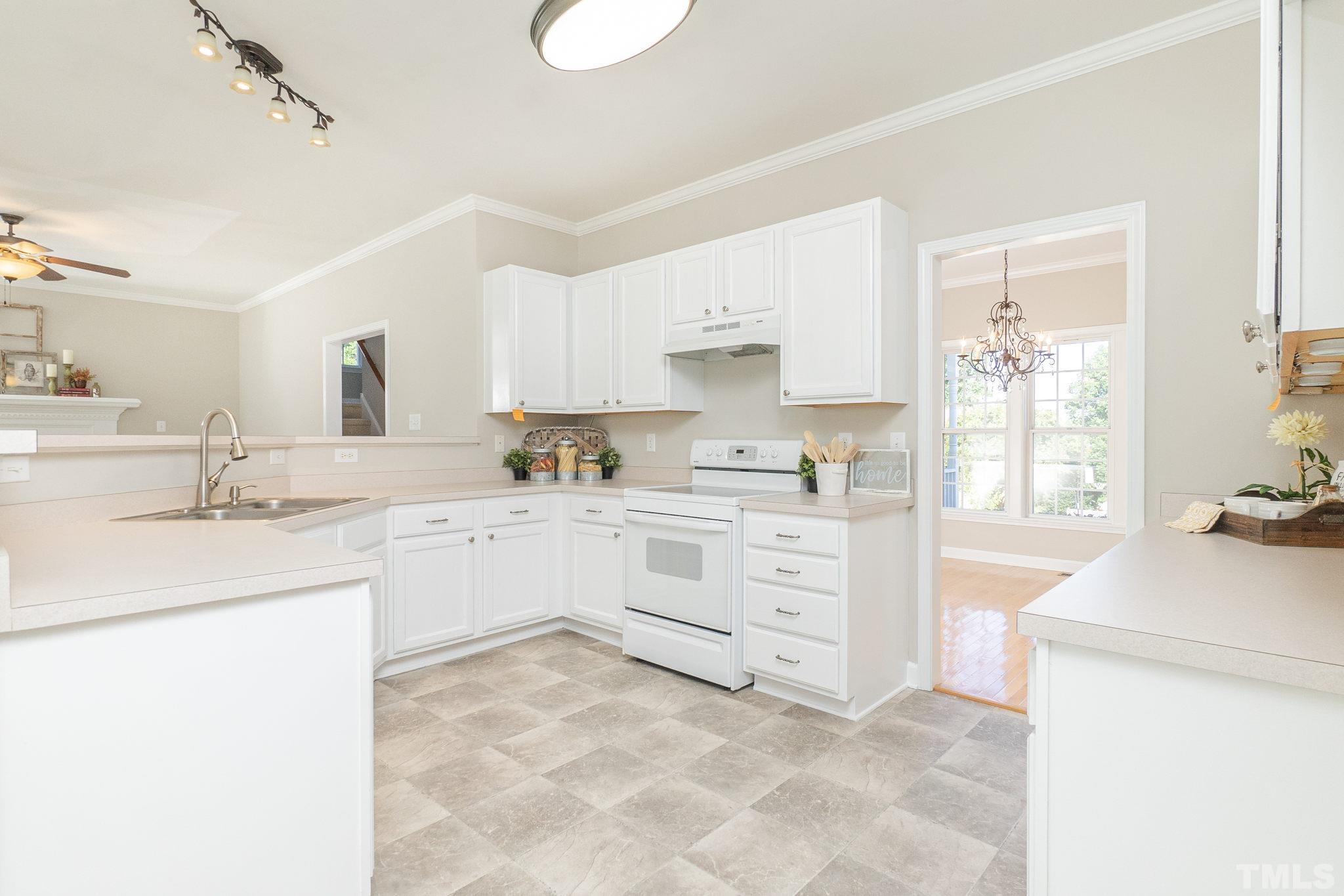 4812 Elmhurst Ridge Court Raleigh, NC 27616 - Photo 9 of 23 a kitchen with granite countertop cabinets appliances a sink and a window