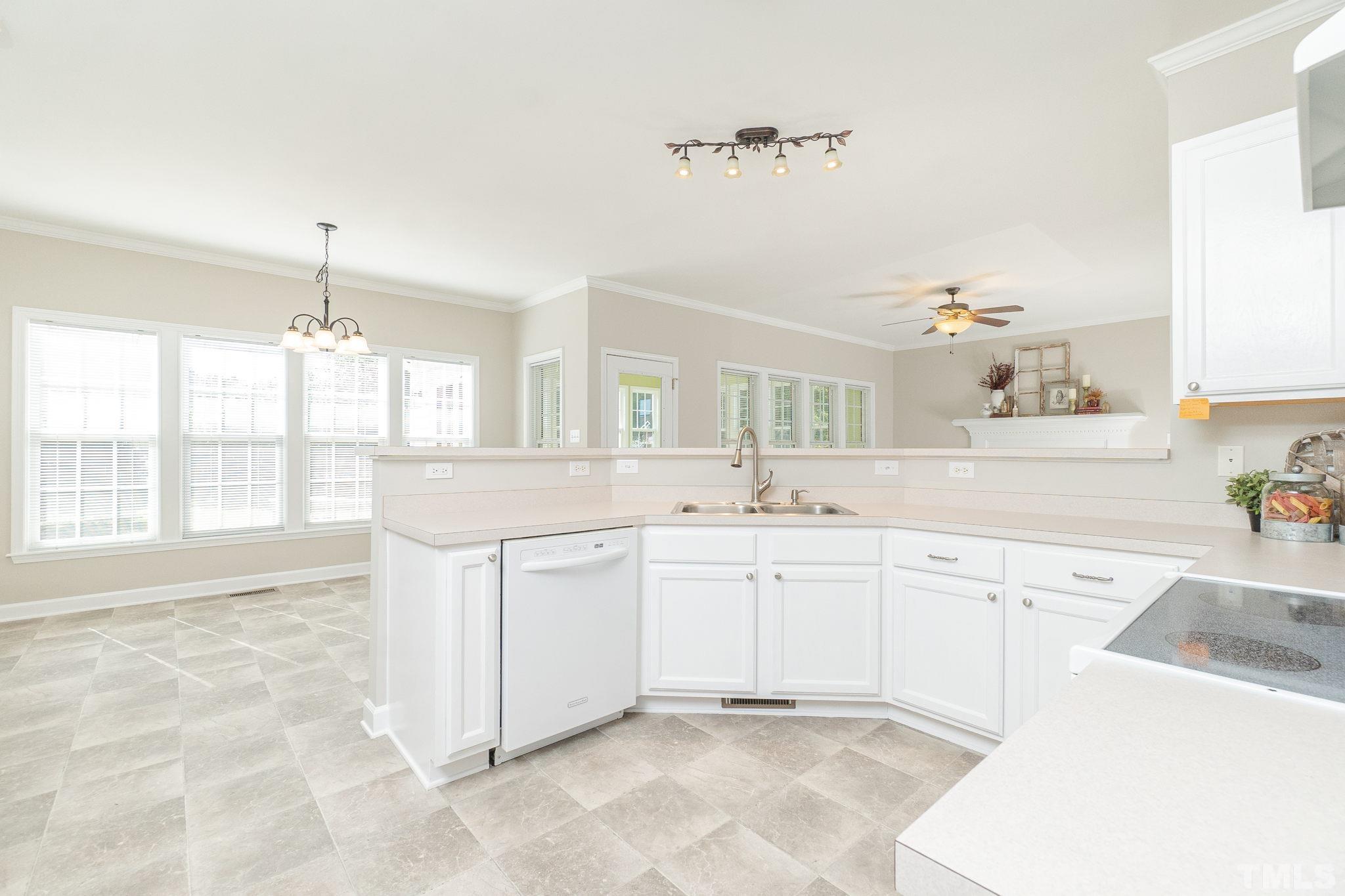 4812 Elmhurst Ridge Court Raleigh, NC 27616 - Photo 10 of 23 a large white kitchen with cabinets and a sink